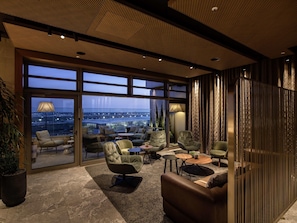 A modern lounge with a panoramic city view, plush seating, and a stylish ceiling design. - b'mine Frankfurt Airport, WorldHotels Crafted (Frankfurt)
