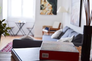 A living room with a sofa, a coffee table, and a book on the table.