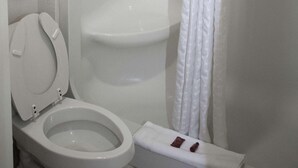 A bathroom with a toilet, a shower, and a towel rack. - Surestay Hotel by Best Western North Myrtle Beach (North Myrtle Beach)
