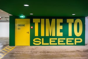 A green and yellow wall with the text "TIME TO SLEEP" and a door labeled "EINGANG".