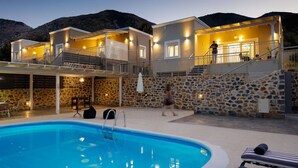 A two-story building with a swimming pool, stone walls, and a balcony. - Family-Friendly villa w/Pool, Children area & BBQ (Vlichada)