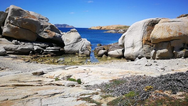 A rocky coastal landscape with large boulders and clear blue water. - Apartment T2 Sea View, Air-conditioned, 4 People swimming pool in the residence  (Lumio)