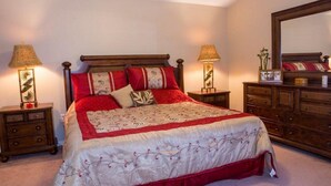 A bedroom with a large bed, two nightstands, a dresser, and a mirror. - IPG Florida Vacation Homes Bella Piazza Resort (Clermont)