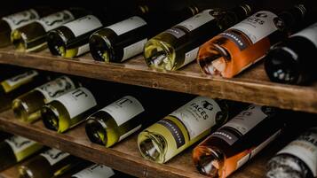 A collection of wine bottles on wooden shelves.