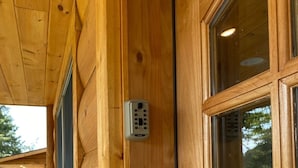 A wooden exterior wall with a window and a door.