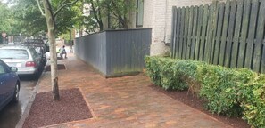Stroll along the paved walkway to this charming house with a brick exterior and an entrance.
