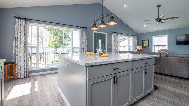A spacious kitchen with a large island, grey cabinetry, and a view of the outdoors. - Seneca Spirit: Gorgeous Views of Seneca Lake! (Geneva)