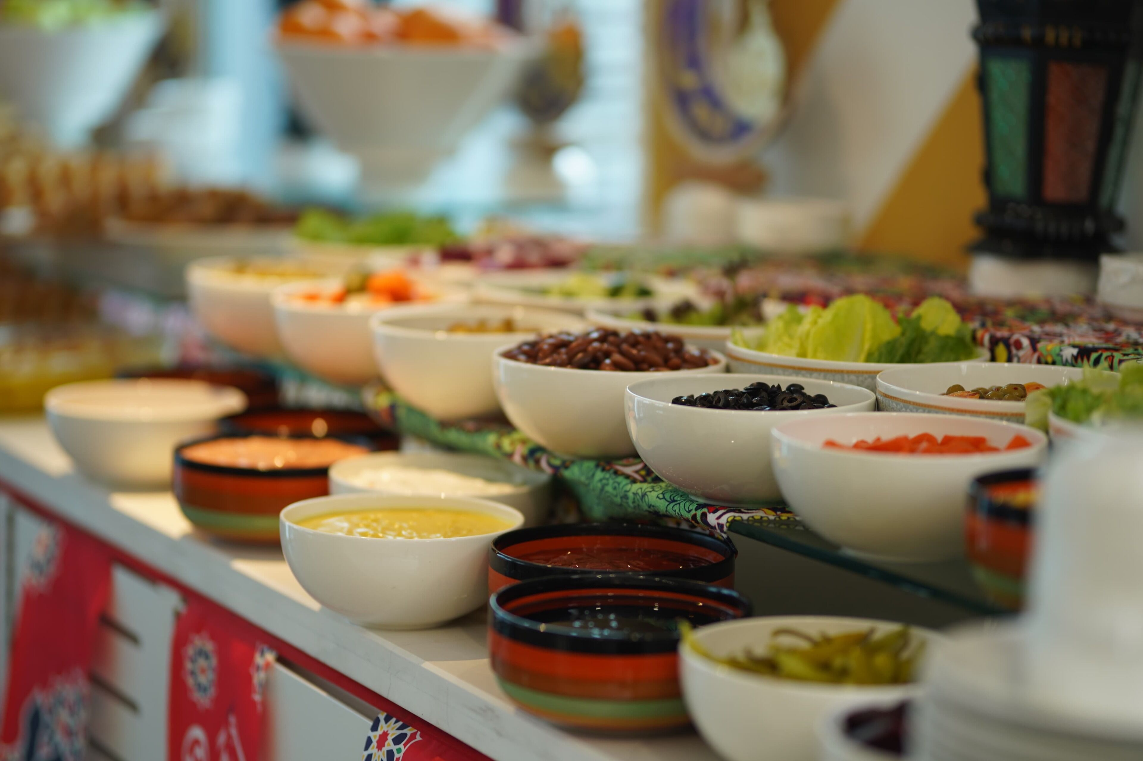 A buffet with various food items and condiments.