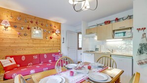A cozy kitchen with wooden cabinets, a microwave, and a sink. - Le cœur des Evettes - One Bedroom Apartment, Sleeps 4 (Flumet)
