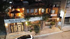 A two-story building with a sign for "Hotel Alcatráz Restaurant & Bar" at the ground level.
