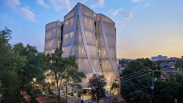 A modern architectural building with a unique design, featuring a prominent, angular structure and a glass facade.