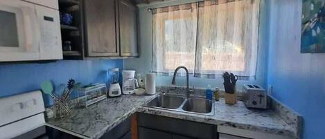 Fridge, coffee/tea maker, cookware/dishes/utensils