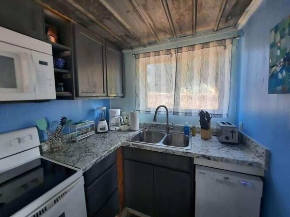 Fridge, coffee/tea maker, cookware/dishes/utensils