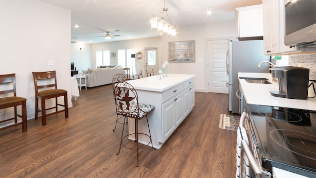 A spacious kitchen with a large island, white cabinetry, and a modern stove. - 2 mi to Old Town ★ Blocks to ⛱️ ★Spacious & Cozy (Bay Saint Louis)