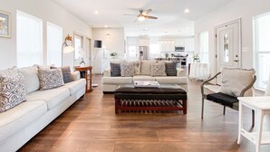 A spacious living room with a large sofa, a coffee table, and a dining area in the background. - 2 mi to Old Town ★ Blocks to ⛱️ ★Spacious & Cozy (Bay Saint Louis)