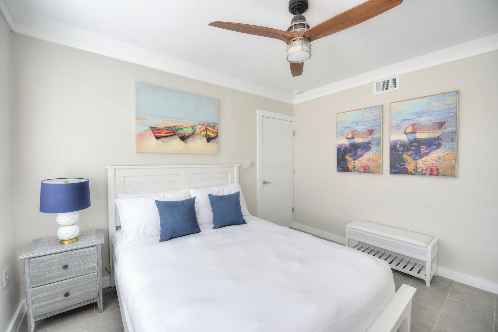 Secondary bedroom with queen bed and 52" smart TV.