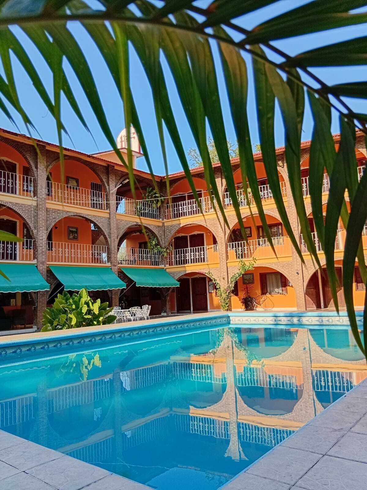 A multi-story building with a swimming pool in the foreground.