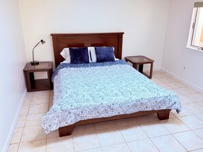 A bedroom with a wooden bed, two bedside tables, a lamp, and a window. - Blue & White Getaway - 5 min to Beaver Stadium (State College)
