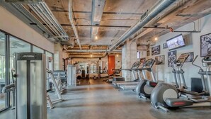 A gym with treadmills, a stationary bike, and weight machines. - Rustic Realm/2BR2Bath/KayBaileyCenter/Pool/GYM (Dallas)
