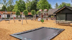 A playground with a trampoline, swings, and a slide. - Pet friendly home in Epe with WiFi (Epe)