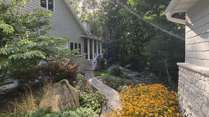A residential house with a stone pathway leading to a porch. - Luxury Retreat in Ellison Bay (Ellison Bay)