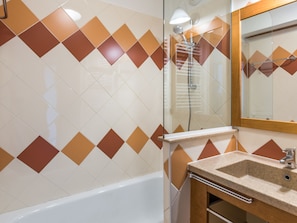 Bathtub, hair dryer, towels, soap