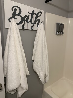 Combined shower/tub, hair dryer, towels, soap