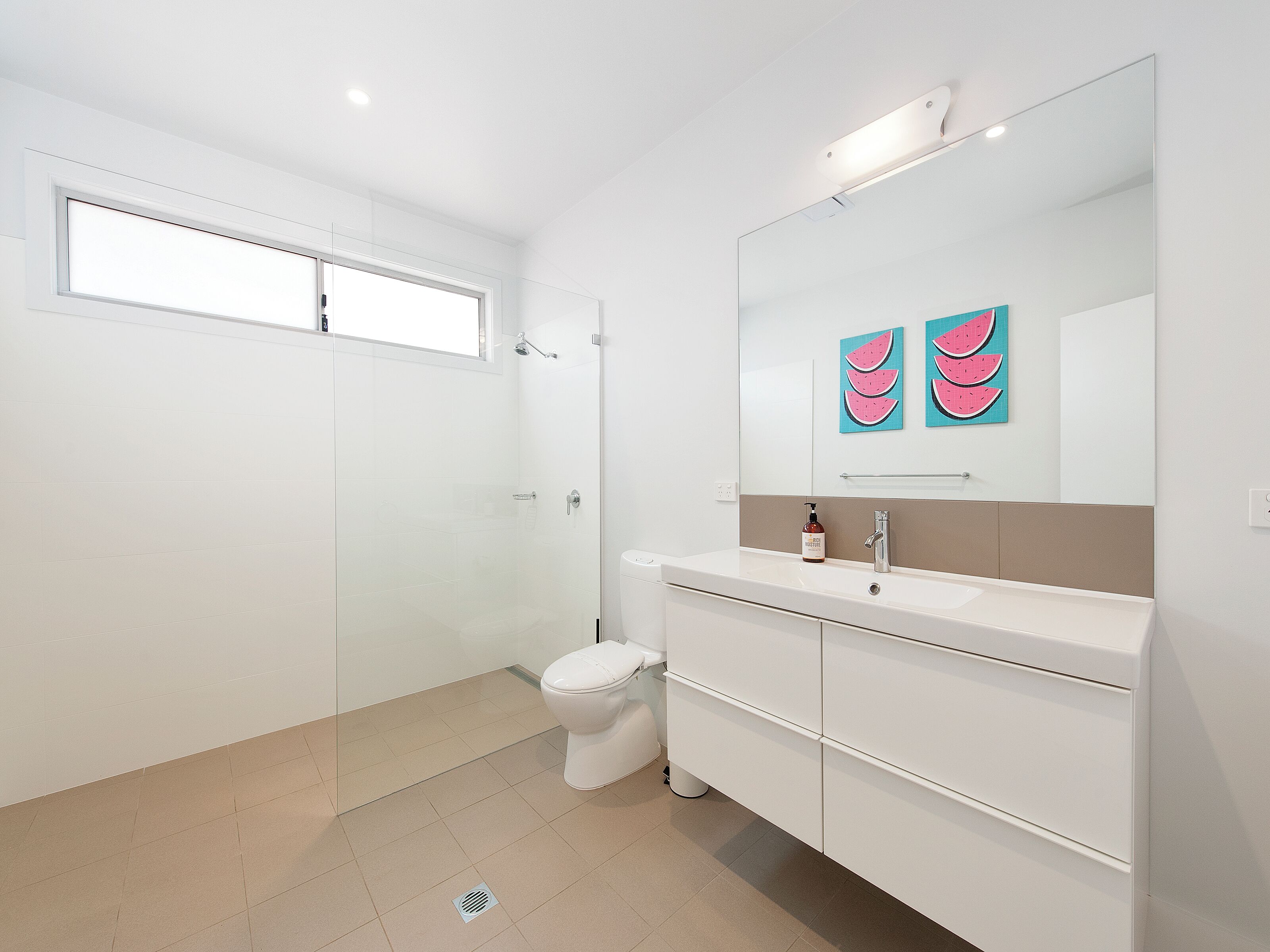 Bright modern bathroom with walk-in shower and sleek vanity
