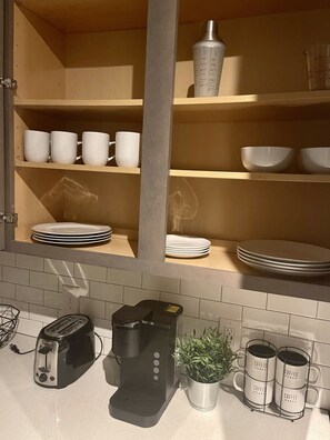 Efficiently designed kitchen with ample storage and essential appliances for meal preparation.