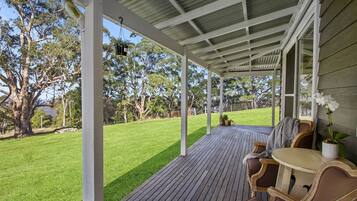 Enjoy al fresco dining on the deck overlooking the beautifully manicured lawn.