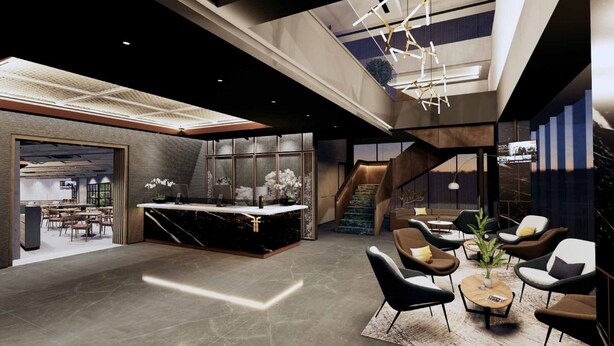 A modern lobby with a reception desk, seating area, and staircase. - Fieris Hotel Rawamangun (Jakarta)