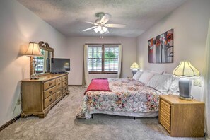 A bedroom with a bed, dresser, ceiling fan, window, and artwork on the wall. - Quiet Home w/ Fire Pit - 1 Mi to Downtown Acworth! (Acworth)