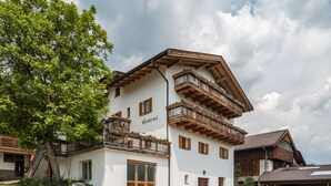 A two-story building with balconies, a wooden facade, and a sign that reads 'Winklerhof.' - Holiday Apartment "Dolomiten Winklerhof" with Mountain View, Garden & Wi-Fi (Villanders)