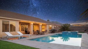 A modern house with a swimming pool, outdoor seating, and a starry night sky. - ❤️Modern 4BR Joshua Tree House w/ heated Pool! (Yucca Valley)