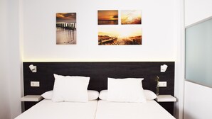 A modern hotel room with a large bed, two bedside tables, and a dark headboard. - Magnificent house with private pool in Granada (Granada)