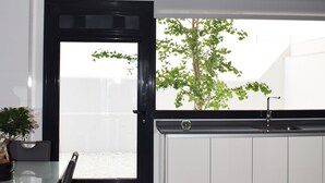 A modern kitchen with a black-framed door, a sink, and a potted plant. - Magnificent house with private pool in Granada (Granada)