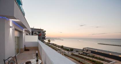 Modern apartment of about 50sqm, with a wonderful terrace of 70 sqm with a view on sea and lighthouse, able to accommodate 4 people with every comfort. The property is located in an enviable position, facing the beach and only 6 km from the airport, in a