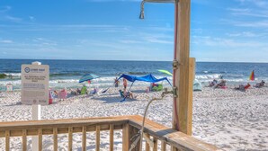 A beach with a sign indicating personal items must be removed daily.