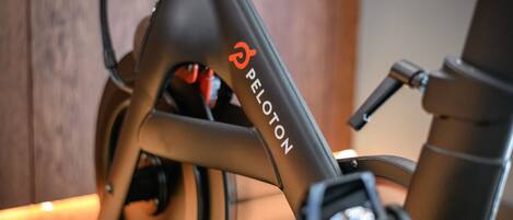 A close-up of a bicycle with the brand name "PELOTON" visible on the frame.