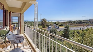 A balcony with a view of a road and distant mountains. - Cisterama 102 (Cape Town)