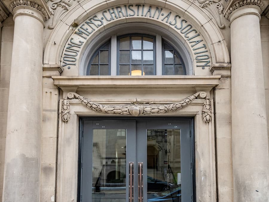 A building entrance with a sign reading "Young Christian Association."