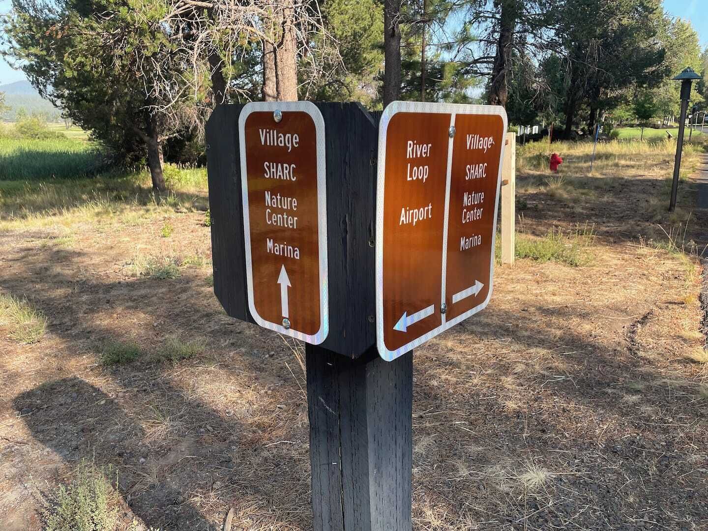 A directional signpost with two panels.