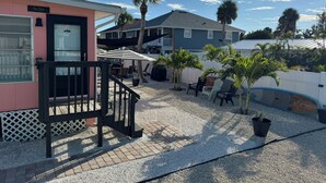A building named "The Jack" with a covered patio area, outdoor seating, and a small pool. - 3's Company-"Villa Janet"- 1 Block from Gulf of Mexico, 300 feet to the Gulf (Englewood)