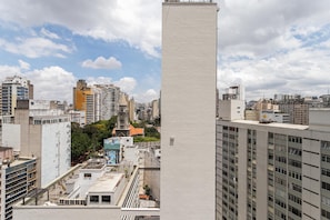 A high-rise building with a modern architectural design, featuring a prominent vertical element in the foreground. - Smart Charlie Consolação (São Paulo)