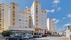 Ein mehrstöckiges Hotel mit modernem architektonischen Design, mit Balkonen und einem zentralen Eingang.