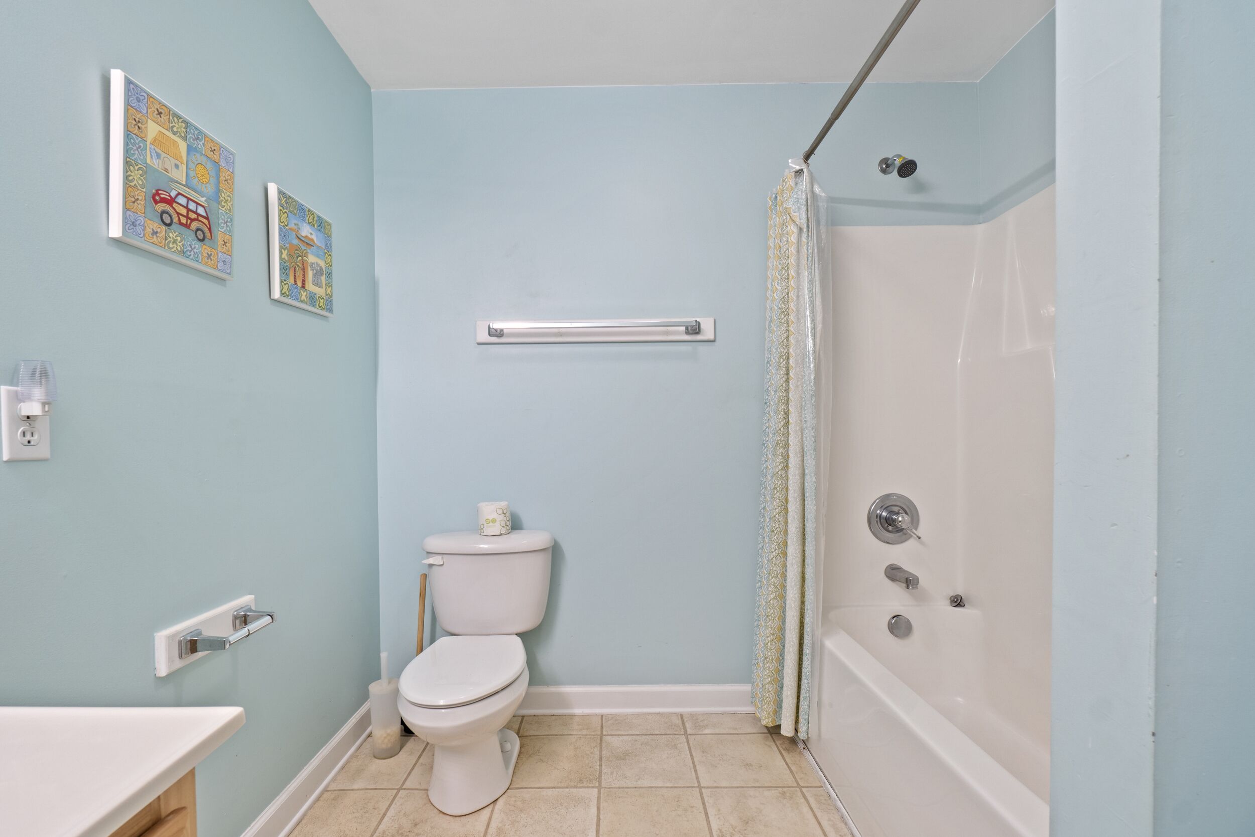 A bathroom with a toilet, a sink, and a bathtub.