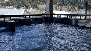 A hot tub with a view of a snowy mountain and a sign that reads "Life is too short to drink head beer." - The Crowe's Nest @ Peaks West (Sun Peaks)