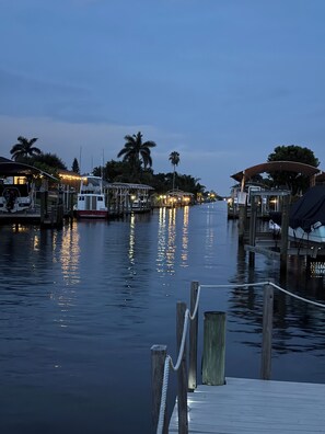 A waterfront dock with moored boats and a covered structure.