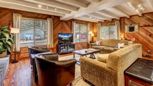 A cozy living room with a fireplace, comfortable seating, and a television. - Paloma Place  Hot Tub | Game Room | Pool Table (South Lake Tahoe)