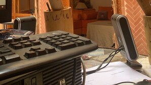 A room with a desk, a keyboard, a mobile phone, and a laptop. There are two potted plants, a chair, and a bed with a blanket and pillows. - RIADJENANADAM Marrakesh  (Marrakech)